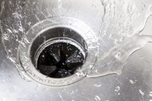 water-swirling-down-a-drain-with-garbage-disposal